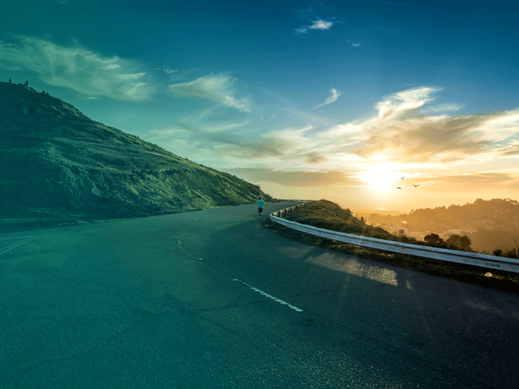 running on road at sunrise