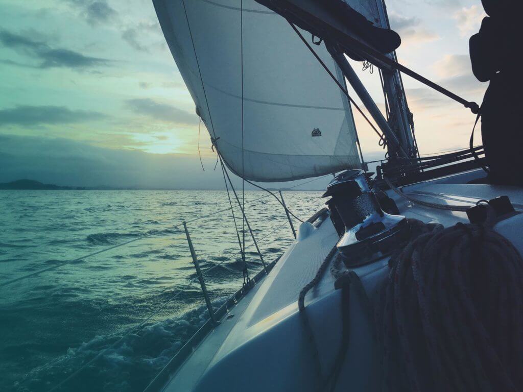 A sailboat heading into the sunset