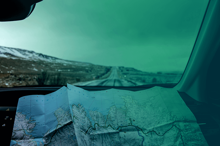 A roadmap spread out in a car
