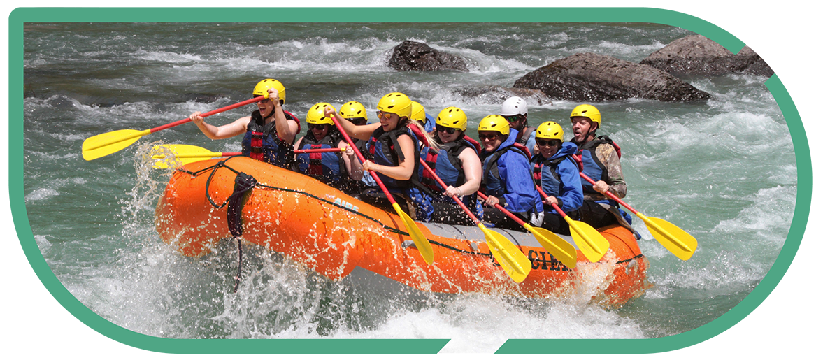 A group of river rafters riding white-water rapids